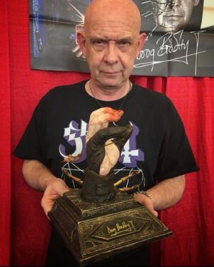 Doug Bradley Instagram - ⛓️🔥⛓️
 Posted @withregram • @robertskyle17
 “I Am The Way” PREORDER! 
Inspired by the iconic moment from Hellraiser Ill: Hell On Earth when Pinhead scornfully removed two worm-adorned pins from his head and drove them through the palms of his hand in a parody of Christ’s crucifixion, and taking Jesus’ own words for himself, blasphemously declared “I am the Way”.
Conceived by Doug’s wife, Steph Sciullo, the hand itself was cast from Doug’s hand by Steph (in their kitchen!). The base and Pinhead’s ‘finger-stalls’ were designed and sculpted by Special Makeup Effects artist Kyle Roberts.
Made from a durable urethane resin, 11” tall, 9” deep, 8” wide.
Each piece is hand-finished by Kyle and individually autographed by @officialdougbradley , making each one a unique item.

I AM THE WAY is priced at $400 plus shipping and handling. All orders will ship by the end of APRIL. Pre-sale of 25 (#5-30) available now first come first served at krobertsfx.com 
.
#hellraiser #hellraiser3 #iamtheway #pinhead #hellraiserpinhead #dougbradley #stephscuillo #sculpture #originalart #clivebarker #tolinfx #krobertsfx #barefootfxstudio #horror #collectibles #horrorart #horrorcollector #collection #robertskyle17