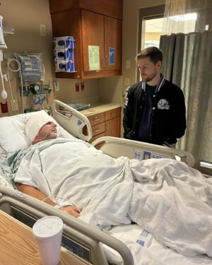 Drew Lynch Instagram - This new year started differently than I was prepared for. My wife took this photo of my dad and I yesterday- a little over 24 hours after he had brain surgery. After experiencing headaches for months, a CT scan found a large tumor on his temporal lobe and the same day he was rushed to St. Vincent’s hospital here in Indianapolis. The neurosurgeon and his team have been nothing short of extraordinary. Within a day they were able to successfully remove the mass and send off to biopsy. We will know more once the results come back but for now, my family and I could not be more grateful to Dr. Payner, his team and the staff here at St. Vincent’s hospital.