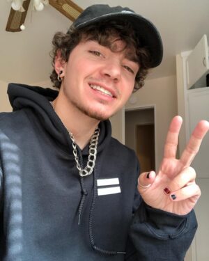 Elliot Fletcher Instagram - i look weird in these pictures but my @getrealmovement hoodie doesn’t!! thank you to them for sending me this hoodie and a matching tee! go grab something from them this pride month and remember to appreciate yourself!