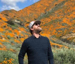 Emily Coutts Instagram - He wanted to hike to the top of the tallest peak. I wasn’t sure he’d be able to but I thought, why not try. We forged a winding path, committed to not hurting a single poppy on the way. We arrived at the peak and sat down for a break. I asked him if he wanted to listen to a meditation about change and letting go, I thought we both could use it. We closed our eyes and listened for 15 minutes, feeling the breeze. When we gently opened our eyes we were surrounded not only by poppies and warm breeze but by hundreds of butterflies dancing around us. We looked at each other, started to smile then laugh. What magic. I will never forget that moment. And now I will picture him there, smiling back at me. Transforming like the butterfly. 

I love you Ken. Rest in peace 🖖🏼