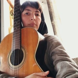 Emily Kokal Instagram - This a lil shoutout to my #1
I got this guitar when I was 8 from my uncle. It was his when he was young, I don’t really think he ever played it much..
And I didn’t really pick it up until I was 16 when I started learning chords from my friend Caitlin and my mom’s boyfriend Bert, who also helped me figure out tab from a Beatlemania book. I’ve written most my solo songs and some warpaint jams on this little low action short-necked classical (almost feels like an electric that way, and made finger picking on electric a natural tranzish)
The sticker with the “brand” came off decades ago.. and I’m sure it wasn’t a name any of us know. 
I’m really lucky, I have a lot of guitars...really nice and special guitars that have been gifted to me over the years but I always come back to this baby.. it’s how I learned and how I found my own feel. It was too flimsy and weird to just strum chords so I started arpeggiating just to get some vibe and that way has just stuck with me. 
I feel understood by it, and I think it feels the same. 
It’s almost impossible to mic or play live cuz it’s so quiet but it’s the perfect writing tool and I should probably put a pick up in it so I could rock it out somewhere. 
Thanks uncle (and mom’s idea I bet) x
You can have the “nicest” gear and the fanciest newest shit but really it’s about what you connect to, and what pulls it out of you that makes it valuable