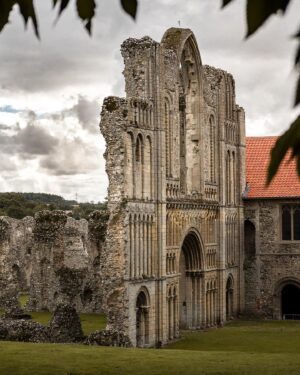 Evelyn Edwards Instagram - The West face of Castle Acre Priory gives you a small glimpse of the glorious carving that might would have been seen all over this amazing church.  Castle Acre priory was one of many monasteries in Britain that was bound to the mother Abbey of Cluny in France.  This Abbey was quite possibly the wealthiest monastic house is the world. The monks at Castle Acre Priory would have had to travel to France to consult or be given direction from the abbots of Cluny. Interestingly, the heads of Cluny only came to Britain five times in the 13th century and twice in the 14th century.  Castle Acre, because they were an offshoot of Cluny Abbey, had to send money to them. Even though most of the monks were English, Castle Acre Priory was still punitively taxed (read as possessions seized and money had to be sent to France) during the wars with France/ Burgundy in the 13th and 14th centuries. A formal charter of naturalization for Castle Acre Priory came in 1351 and it became considered a “native” English priory. ⁣ #churcharchitecture #englishhistory #england