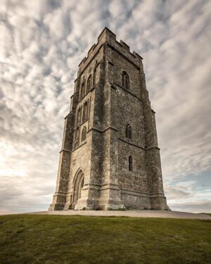 Evelyn Edwards Instagram - Whenever I look at Glastonbury Tor, I marvel at how far away you can see the hill that the remaining tower of St Michael’s Church can be seen. I think about all the people who have climbed this hill in the past, and those that still do literally daily that draw inspiration from this landmark.  I, too, have climbed the hill and walked up the steps of the Tor and stood in wonder. The Tor has so many legends associated with it- you could spend a lifetime following the trails of the marvelous tales of King Arthur , Avalon and the door to the fairy realm, the holy grail…. It seems we humans are forever finding wonder in nature and trying to explain the unexplainable. ⁣
.⁣
.⁣
.⁣
.⁣
.⁣
#glastonbury #glastonburytor #avalon #churcharchitecture #kingarthur #historicalplace #ruins #somerset #visitsomerset #loveforsomerset #ilovesomerset #igerssomersetuk #igersuk #bbcwest #ukpotd #gloriousbritain #photosofbritain #landscapephotography #legend #britains #wanderlust #divinefrminine #ukscenery #pagan