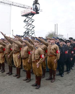 Finn Wittrock Instagram - In 1936, a German man, presumably identified as August Landmesser, was photographed refusing to perform a Nazi salute and crossing his arms in defiance.

Swipe to see behind-the-scenes photos of how this shot was recreated in #AvaDuVernay’s ORIGIN.

#ORIGINMovie is now playing in theaters. Get tickets at originfilm.com via the link in bio.