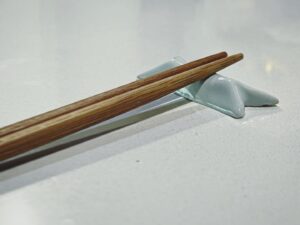 Freddie Wong Instagram - You often hear about forms that ceramicists have made “thousands of times,” refining the shape over many iterations.

As I’m just a beginner I thought I had no such forms, but I realized that there IS something I have made probably thousands of times - little chopsticks holders folded from the paper chopsticks often come in. 

This is a shape I’ve been making for years, so I tried my hand at creating a mold out of plaster to cast it in porcelain. Next iteration I think I will leave unglazed, as the plaster captures a subtle paper texture present in the origami versions.