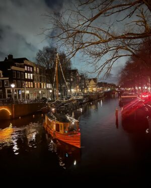 Frederique van der Wal Instagram - Amidst the rain and gusting winds, a sudden trickle of sunlight emerges, transforming into a magical sunset. 

It’s the kind of light that makes you pause in your tracks, abandoning any hurry to capture another beautiful moment in Amsterdam. 

And as the night sky descends, the lights in the houses illuminate, enveloping you in a feeling of living inside a snow globe. 
Merry Christmas!

❤️Amsterdam