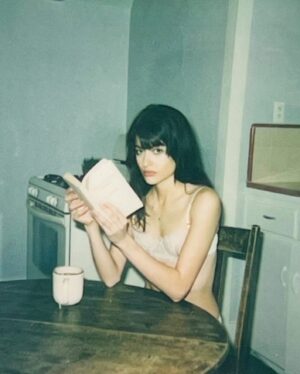 Gabriela Quezada Bloomgarden Instagram - a series of hot grumpy photos of me pretending to read interrupted by loupac, a murder, and a beautiful day idk