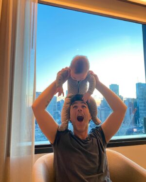 Geraldine Hakewill Instagram - An appreciation post for our baby, who has put up with (very lovely) babysitters, a (very lovely) hotel, and two very tired and distracted parents. We love you mate. And we love @melbfilmfest 🌟 thanks for looking after all of us and our film. Next stop, @cinefestoz 🐓

ID: Image one - a woman in a hotel robe holds a baby. She is smiling with her eyes closed as he plays with her hair. 
Image two - a man sits in a chair with a baby balanced on his head. He looks up at the baby, making an excited face. Behind them is a view of the Melbourne skyline.