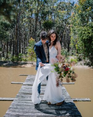 Geraldine Hakewill Instagram - When Mark and I surprised our family and got married over Christmas I was very lucky to have my 11th hour dress made for me by my friend @biancaspender 🌸 It was like a second skin and it helped me feel effortlessly glam and special. She is releasing a new bridal collection soon and you could wear your very own creation down the aisle/forest path/jetty… I can highly recommend.
Mark had his linen suit custom made by the amazing @annacordell_ and we both wore our @rmwilliams boots. Our local flower farm made my bouquet @fleurs_de_lyonville and a beautiful neighbour and now friend @clairderwortphotography took our photos. Another friend @i_am_jika made our rings from recycled gold. 
I did my own hair and make up which the wind and my tears quickly made short work of. I got sunburnt shoulders and felt giddy and couldn’t stop smiling all day.