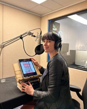 Geraldine Hakewill Instagram - Deeply stoked to be narrating the audiobook of PRIMA FACIE by @suziemillerwriter ❤️ Such an urgent, smart and visceral piece of writing (made famous by some extraordinary actors on the stage *coughcough* @miss_harbinger ) and the best recording experience with @keenanjwardrope at @bolindaaudio ⚖️ Out Sept 26th

ID: A woman with dark hair and headphones on sits in a recording booth in front of a microphone. There is an iPad propped up on the table in front of her with a book cover on it that says “PRIMA FACE Suzie Miller”
