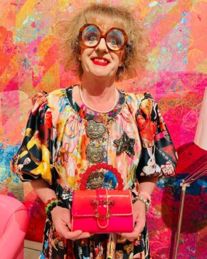 Grayson Perry Instagram - Overdoing it tonight, spooky Alan Measles dress by #CSM student Rosie Crompton, super sweet bag by @SOPHIAWEBSTER brooch @AndrewLoganAMW 
Mad stare, model's own
