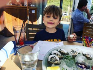Heather Tom Instagram - So he is my child after all! #oysters #foodies #adventures #santabarbara #beachday #california #californiaboy #ocean #cali #water #watersign @_theboathouse #dogbeach day