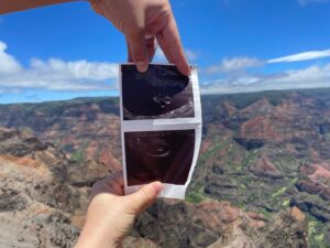 Heather Vaughn Instagram - I found out I was pregnant a couple weeks before we finally left for our honeymoon to Hawaii. Y’all I was so miserable omg. I was nauseous every second every day for basically the entire months of August and September 😂 Luckily the nausea passed after the first trimester BLESS. I’m actually really surprised by how good I’ve been feeling lately! 

I just had to post this picture we took of little bb girl at Waimea Canyon in Kauai because I think it’s really cool :3 (it was super windy up there I’m shocked that ultrasound pic didn’t fly away 😂)