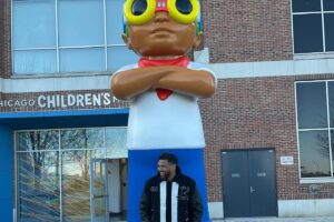Hebru Brantley Instagram - New statue 🚨! Flyboy has a permanent home at @navypierchicago When I first started my career as a visual artist I dreamt of having a public sculpture in my home town. This weekend that dream came true. All smiles as history is made. Thank you to everyone That has helped through their support their love or their hard work to make this a reality. I wouldn’t have made it to this point without you. Special thx to the Wong family We just getting started!  #chicago #navypier #navypierchicago #grateful #nevermorepark #flyboy @hidden_s_rank