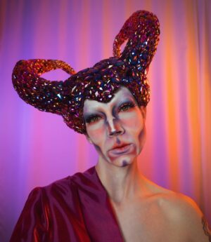 HercuSleaze Instagram - I’m entering a new era of my drag 💜For a year after the tv show aired I was able to pay my bills by performing & teaching drag, and with the occasional sponsored post. I felt lucky to be able to turn my passion into a career but the increased attention that came with it made my anxiety skyrocket! I felt tied to the treadmill of maximizing the exposure I’d received and it stripped away a lot of my love for the artform. This year I’ve been processing that pressure and those high expectations, and I’ve been taking space back in my life for Meags. I’m finally at a place now where I’m at peace about doing just what I can and only what feels good. My goal is to make looks that interest me and to perform acts that make my friends laugh. If I can still book the occasional well paying gig here and there, I’ll be grateful for those opportunities! 💜 Hooray for improved mental health!

😈 Headpiece by me
📸 Photography by me

#dragking #dragkings #dragartist #canadiandragking #canadiandrag #dragphotography  #dragqueen #malecontour #dragkingmakeup #femmeking #montrealdrag #dragmtl #canadiandragking #canadiandrag #instadrag #dragphotography #androgynous #genderbender #performanceart  #queerart  #dragkingsofinstagram #dragkingvisibility #alldragisvalid #canadianmua