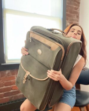 Holly Deveaux Instagram - This is my favorite old suitcase. I bought it twelve years ago when I had to travel for a film shoot for the first time. We’ve been through so many airports and hotels together.

I have to get another one because I have far too many books to fit, and this guy is overdue for retirement. I’m sending it to a lovely suitcase farm where the suitcases get to roll across the fields in the sunset.

I’ll miss you, old boy.