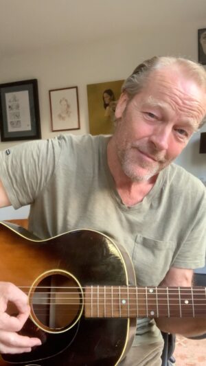 Iain Glen Instagram - Thought I‘d share the odd musical offering with you! Playing guitar has kept me sane over the years while on location. Actors spend so much more time waiting than filming on a typical day. This helps me while away the time and it doesn’t mess with my acting head.
