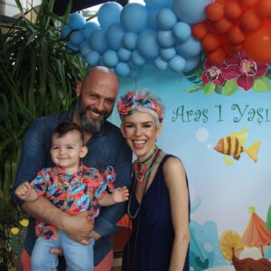İpek Tanrıyar Instagram - OĞLUMA İLK MEKTUP:
Sen
ki bütün ettiğim büyük lafları bana afiyetle yedirmeyi başaran küçük adamm.. 
Artık aynaya bakmadığım günler var,arayanlara geri dönemediğim saatler,haftalar..
Bıraktım artık kusursuz olmayı,evi mum gibi toplamayı,o çok sevdiğim sabah 9-11 uykularını..
Salonda yer gök oyuncak,toplamıyorum dağılanları..
Hayata merhaba dediğin gün bana en zor sorumluluğu verdi rabbim..yorgunmuyum evet..
Bıraksalar 2 hafta uyurum.Uyuduğunda ya şimdi uyanırsa diye ertelediğim dünya işim var.Ama senden daha güzel bir işim yok..Dünya yansa yüzüne bakınca unutuyor insan dünyevi sıkıntıları..Böyle bir rehabilitasyon dünya üzerinde var mı?
Hiç bir açıklaması yok sen yemeğini bitirdiğinde ve kakanı yaptığında mutluluğumun..ununu eleyenler anne olmak demişler.
Zor işmiş vesselam,zaman yavaş ama yetişemediğim kadar da hızlı..
Ama hayat da zor..Dünya artık kötü bir yer, o yüzden kalkmaya çalışırken düşüp ağladığında koşmuyorum yanına,düşüp kalkabilmeyi bil diye,bir oyuncağını sıkıştığı yerden alamadığında o yüzden yardım etmiyorum hayatta tuttuğunu koparabil diye,bardak çanak bibloları ellemeye çalıştığında o yüzden sesimi çıkarmıyorum herşeyi görerek dokunarak tanıyarak öğren diye..insanlardan o yüzden esirgemiyorum hayatta onlarla olacaksın diye..
Ama bütün bunları yaparken vicdanımı da koyuyorum önüme ben olmaz desem de o seni kucaklasın diye..
Ne dersem diyeyim de.. 
hayat hep güzellikler getirsin bebeğime,altından kalkabileceğin yükler yüklesin yüreğine..
Adam gibi adam olabilmek için çalış dersine,kitabın da baban olsun Aras’ım 
Sevgilerimle…. İYİ Kİ DOĞDUN🧿 #arasbebek1yaşında
