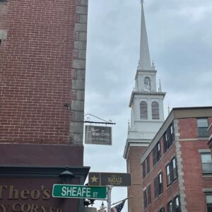 Janna Levin Instagram - My former street corner in The North End, Boston. My roommate was Shep Doeleman, who became the director of Event Horizon Telescope. We were deep in tumultuous graduate school struggles. Capturing an image of a black hole was a foolish dream. Gawd we laughed so much. There were some tears too.

To think that in an uncertain future, I'd travel to the National Press Club to watch Shep reveal the image, to join a billion people around the globe looking together in that moment at a black hole 6.5 billion times the mass of the sun & 55 million light years away...gah. What a time to be alive.

In the background, The Old North Church: “One if by land. Two if by sea.” And all that.

#BlackHoles #BlackHoleSurvivalGuide 

@ehtelescope @mitpics