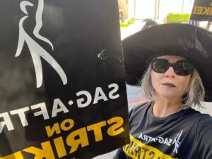 Joanna Going Instagram - Proud to be a SAG-AFTRA member since 1986. 
Proud to walk the SAG-AFTRA picket line. 
Proud to support our fierce Negotiating Committee. 
Proud of all  the members staying strong and fighting for a fair share. 

Actors work hard. Actors — from leads, to supporting players to background — contribute, on and off the set. The job begins long before “Roll camera” and ends long after “That’s a wrap”. 
Actors work hard at making audition tapes, researching roles, prepping to perform. 
Actors work hard at promoting film and tv projects with hours, days, weeks of press junkets, interviews, photo shoots, social media. 
Actors work hard for health insurance — and the majority of union members, who are paying their union dues, don’t make enough money to get union health insurance. 
I’ve been a working actor and union member for 37 years, and I don’t qualify for health insurance. 
Streaming is not “new media” anymore. It’s time to pay actors fairly for their work. 
Actors give their hearts and souls and passion guts to the work, and our worth is being threatened by soulless AI. 
Actors love what we do. 
We want to give you what we do. 
Actors— leads, supporting players, background — contribute and deserve a small piece of the billions that the studios make every year.
#SagAftraChallenge
#SAGAFTRAStrong
#SagAftraStrike
#Power2Performers