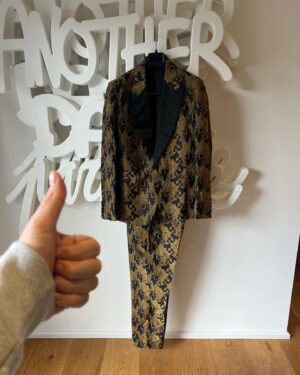 Joel Dommett Instagram - WIN THIS MASKED SINGER SUIT for £5! Help us raise some incredible money for @braintumoursupport by entering the raffle for this beautiful @joshuakanebespoke suit - plus a little personalised message. Tickets are £5 and it all goes to an amazing charity that supports families affected by brain tumours. Enter now - link is in my bio! It’s one of my favourites 🥰