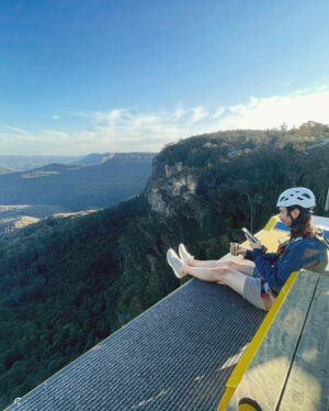 Joey Richter Instagram - 🧗🏻‍♂️WILD Australian Photos Incoming 🌄 On me & @slowpez8’s lil post-tour adventure in the #BlueMountains of NSW ⛰️, we were treated to the MOST special experience at @scenicworld_aus! During our time there we discovered firsthand that the Blue Mountains are maybe the most beautiful place in the world?? (Top notch rec from @a.j.holmes 🥇) #ScenicWorld_Aus is located in Katoomba, a mountain town that overlooks the 🤩BREATHTAKING🤩 Jamison Valley, which features the iconic #ThreeSisters 🏜️ (needless to say, it’s all fuckin stunning!). Scenic World offers 4 main attractions: Scenic Walkway 🦕 (endless rainforest paths feat. Dinosaurs — like in Slide 9), Scenic Railway 🚃 (steepest in the world!), Scenic Cableway 🚠 (ALSO steepest!), & Scenic Skyway 🚟, which sits 270 meters above the canopy below 😳

But then there #BeyondSkyway 😎 Something that I’d NEVER think I’d have the chance to do… but did!! Not only did we ride the skyway out into the center of the valley, but we got strapped in to climb ON TOP of the car 🫣 & privately enjoy the sunset w/ hot chocolate and champagne 🥂 I couldn’t fuckin’ believe it!

Now I’m prone to death-defying experiences only SLIGHTLY more than Lauren (exhibit A - her face in Slide 2)🪂 But our wonderful guide, Tony, could not make us feel safer while also encouraging us to lean out and soak in the landscape 🌅 PLUS he put up with our ONE MILLION questions about weather/how secure our rig was/the structural integrity of the cable car 🤔🤦🏻‍♂️

It was an unforgettable afternoon and I’m SO glad we worked up the courage to go for it! 🎢 Enormous thanks to Tony (pictures in Slide 10!), the whole Beyond Skyway team for being so nice to us (& also answering so many questions 🧐), & @bernsokol for being SO generous to set up this once-in-a-lifetime experience for us! 🥰
.
.
.
#explorebluemountains #australia #nswparks #skyway #daredevils #sunsetview #marriedlife💍 #coupleswhoclimbontopofcablecarsSTAYtogether