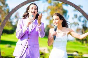 Joey Richter Instagram - 🚨WEDDING PHOTO DUMP PART 1 OF ???🚨

Our ceremony was a dream and we couldn't have done it without our beautiful friends! We are so grateful!

1) Ok this is actually us exiting the ceremony but it's a fun pic!

2) Dylan Darren and Jordan sang us down the aisle with truly the most BEAUTIFUL arrangement of You're Gonna Live Forever in Me 

3) Joey and I listening to them sing. I SOBBED all my makeup off in the first 2 mins of the wedding bc their voices were so beautiful. Spent the rest of the ceremony looking like Ozzy Osbourne. That is how life goes! 

4) A tight 5 to open the ceremony, as god intended

5) Nick was our officiant and it meant so much to us! He is one of our dearest friends 🥹 Plus he killed it! 

6) Joey and I each picked a friend to give a lil speech! Joe was Joey's pick, he did an amazing job AND managed to work in GG and Lost.

7) Julia was my pick and she gave a beautiful speech and made us cry and feel reflective, per usual!

8) We laughed through the whole fuckin ceremony! I look terrifying when I laugh, but that is also life!

9) Exhibit B

10) Friends, legally bound. 

There will be more dumps, sorry gurlies!!!

All 📸 by @annielesser !
#worldsfirstwedding #wedding #clowns #love #gilmoregirls #OfficialJLoWedding