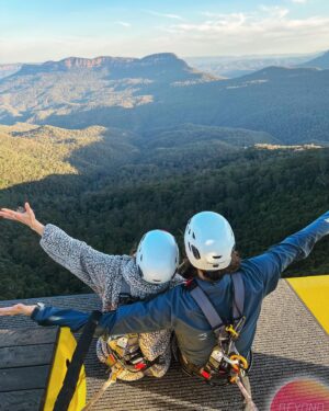 Joey Richter Instagram - 🧗🏻‍♂️WILD Australian Photos Incoming 🌄 On me & @slowpez8’s lil post-tour adventure in the #BlueMountains of NSW ⛰️, we were treated to the MOST special experience at @scenicworld_aus! During our time there we discovered firsthand that the Blue Mountains are maybe the most beautiful place in the world?? (Top notch rec from @a.j.holmes 🥇) #ScenicWorld_Aus is located in Katoomba, a mountain town that overlooks the 🤩BREATHTAKING🤩 Jamison Valley, which features the iconic #ThreeSisters 🏜️ (needless to say, it’s all fuckin stunning!). Scenic World offers 4 main attractions: Scenic Walkway 🦕 (endless rainforest paths feat. Dinosaurs — like in Slide 9), Scenic Railway 🚃 (steepest in the world!), Scenic Cableway 🚠 (ALSO steepest!), & Scenic Skyway 🚟, which sits 270 meters above the canopy below 😳

But then there #BeyondSkyway 😎 Something that I’d NEVER think I’d have the chance to do… but did!! Not only did we ride the skyway out into the center of the valley, but we got strapped in to climb ON TOP of the car 🫣 & privately enjoy the sunset w/ hot chocolate and champagne 🥂 I couldn’t fuckin’ believe it!

Now I’m prone to death-defying experiences only SLIGHTLY more than Lauren (exhibit A - her face in Slide 2)🪂 But our wonderful guide, Tony, could not make us feel safer while also encouraging us to lean out and soak in the landscape 🌅 PLUS he put up with our ONE MILLION questions about weather/how secure our rig was/the structural integrity of the cable car 🤔🤦🏻‍♂️

It was an unforgettable afternoon and I’m SO glad we worked up the courage to go for it! 🎢 Enormous thanks to Tony (pictures in Slide 10!), the whole Beyond Skyway team for being so nice to us (& also answering so many questions 🧐), & @bernsokol for being SO generous to set up this once-in-a-lifetime experience for us! 🥰
.
.
.
#explorebluemountains #australia #nswparks #skyway #daredevils #sunsetview #marriedlife💍 #coupleswhoclimbontopofcablecarsSTAYtogether