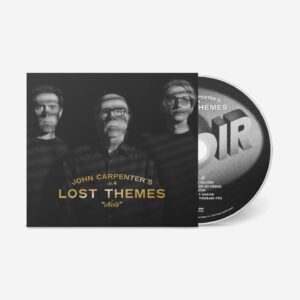 John Carpenter Instagram - Big news today! The iconic trio @johncarpenterofficial , Cody Carpenter @ludrium and @daniel_davies are back with their highly anticipated fourth installment in the Lost Themes series, Lost Themes IV: Noir. Pre-order a copy, releasing on May 3rd, on @sacredbones mail order on exclusive red splatter on clear vinyl, while supplies last! The most limited versions of the record all come with a bonus 7” “Black Cathedral” with a screen printed B side and a poster, and our mail order exclusive version comes with exclusive alternate silver foil.

It’s been a decade since John Carpenter recorded the material that would become ‘Lost Themes’, his debut album of non-film music and the opening salvo in one of Hollywood’s great second acts. Those vibrant, synth-driven songs, made in collaboration with his son Cody Carpenter and godson Daniel Davies, kickstarted a musical renaissance for the pioneering composer and director. In the years since, Carpenter, Carpenter, and Davies have released close to a dozen musical projects, including a growing library of studio albums and the scores for David Gordon Green’s trilogy of Halloween reboots. With ‘Lost Themes IV: Noir’, they’ve struck gold again, this time mining the rich history of the film noir genre for inspiration. 

John Carpenter, Cody Carpenter and Daniel Davies’s Lost Themes IV: Noir joins the 20th installment of the Sacred Bones Record Society! Enroll now to receive the album on society exclusive black and white splatter on clear vinyl, housed in a deluxe wrap-around, hand-numbered sleeve with a wax seal. The record also come with an exclusive artist curated piece of ephemera. The society exclusive version also comes with a bonus 7” and alternate silver foil. Joining these releases will be the next 2 eligible releases, each with the most limited color vinyl variant, special sleeves and artist curated ephemera. join now by purchasing Sacred Bones Society 20 on the @SacredBones website.