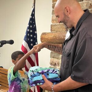 John Fetterman Instagram - Thx to all yinz for coming out to the Penn Ag Dems picnic today – especially the Bedford Co Dems, who made us this beautiful quilt🔥 and @tiedyebytuukka for the shirt☮️ 
I think we can all agree he helped me step up my wardrobe.