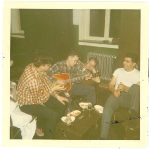 John Prine Instagram - John Prine singing songs circa 1966 during his military days in Germany.

“Sitting on my bunk in the barracks, in Germany, playing my Gibson Hummingbird. My Dad shipped it over to me. That’s my buddy Arnie, from the song ‘Pretty Good,’ where I sing ‘…I got a friend in Fremont…’ I’d just sing for the guys. They always wanted to hear me play. They all liked country music except for Arnie, he thought it was corny. I was writing songs in the Army, but I was just singing the songs I’d learned to sing for my Dad.”