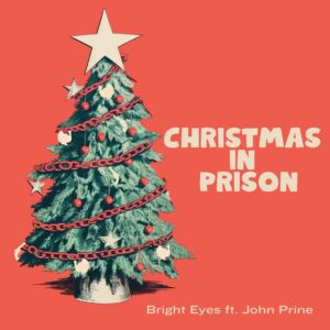 John Prine Instagram - Today’s the day! 🎄🎅

To celebrate the holidays, Bright Eyes offers their own version of John Prine’s “Christmas In Prison.” Featured within the song is a sample from “A John Prine Christmas,” released in 1993.

All proceeds from the single will benefit @sayhellointhere, which was established by the family after John’s passing to honor his kind and generous spirit. You can also nab a special edition Prine x Oberst holiday ornament. Each purchase comes with a download of the track along with a festive digital Christmas card for fans to send to their friends and family. Visit the link to learn more.

Funds generated by the release will be divided between the four major @sayhellointhere grantees for 2023: @porterscall, @tnimmigrant, @renewal_house, and @nchvorg.

📷 by @lindzbest