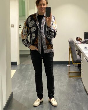 Jonathan Ross Instagram - Show day. Last recording with an audience for a while. But vintage Versace helps lift the Lockdown blues. Stay well.
