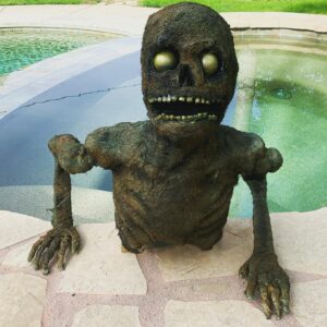 Jorge Garcia Instagram - Only 345 days till Halloween!
-
Groundbreaker made from:
a foam wig head,
plastic skeleton parts,
polyester batting,
liquid latex,
hot glue (teeth),
ping pong balls, 
the void created by a canceled Halloween,
and one pandemic to keep me home.
Corpsing with the batting was a new experiment, don’t love it, it kind of gave him a muppet-like texture. But it could be painted to look like moss. Now he’ll live in the garage till next October.