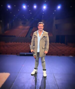 Juan Pablo Espinosa Instagram - Mi Amor por el teatro y la actuación nació de muchas maneras sobre este escenario. Es el teatro de mi colegio en Bogotá. Mientras mis compañeros jugaban futbol en el recreo, yo me venía a este lugar a soñar en grande!
Uno de mis momentos favoritos fue cuando tenía 12 años y decidí presentarme en “La mañana del Talento” con doblajes de canciones…entre ellos Frank Sinatra, New York New York. Use un Abrigo y un paraguas… y ahora aquí de nuevo con la misma pinta, mismos sueños solo unos añitos después 😜 

My love for theatre and acting was in many ways born on this stage. It’s the theatre at my height school, and while my classmates were playing soccer, I would sneak in this wonderful space to daydream! 
One of my favorite memories was performing at the talent show when I was 12, did a lip sync to Frank Sinatra version of New York New York… among others 🤣 I wore a coat and an umbrella, and here I am a few years later same outfit same dreams!