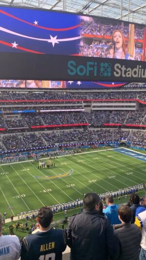 Juliette Goglia Instagram - singing the national anthem at the rams v chargers game at sofi stadium in front of 70,000 people on new year’s day! starting 2023 off right! surreal, outrageous, WILD. thank you @rayvonowen @gtindahouse @chargers @rams 💙💛 #boltup
