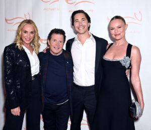 Justin Long Instagram - Great SCOTT! It’s Doc Brown, Marty McFly and… a random Hill Valley student from The Enchantment Under The Sea Dance…? 
Though this could’ve easily been taken at a “Back To The Future” fan convention, this fan got to support his favorite actor at the @michaeljfoxorg’s annual #FoxGala - which has raised nearly TWO BILLION DOLLARS for Parkinson’s research - essential to finding better treatment and, one day, a cure for this disease. I couldn’t have been more jazzed to be a part of this night (as you can see from the huge, almost maniacal, smile on my face). Anyone who knows me knows what a massive influence @realmikejfox’s acting has been to me but it’s his courage, perseverance and HUMOR in the face of challenge that is inspiring way beyond any performance - if you’ve seen #Still on @appletv or read any of his great books, you’ll know exactly what I mean. If you haven’t seen it, why don’t you MAKE LIKE A TREE and check it out ❤️🕰️🛹☢️

Learn more and get involved at michaeljfox.org