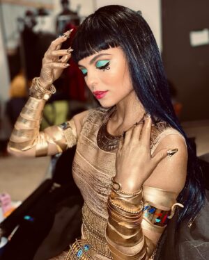 Jy Prishkulnik Instagram - In all her golden glory, I give you the beguiling Princess of the Nile, Miss Cleo de Nile 🪲

This post is dedicated to the skilled artists who brought every aspect of these characters to life, considering everything from the tiniest details to the cohesiveness of the entire cast. Ashley, I had the best time sitting in your chair every morning at 3 am as you painted my face and we gabbed about everything under the sun. To the entire hair team, you are wizards. Ellen and wardrobe, your vision is a dream.

To…

Makeup by: @ashley_pilkey 
Key Makeup by: @leahehman 
Key Hair by: Debra Wiebe @trishawnaalecia @miss_tamtam 
Key Wardrobe by: Ellen Anderson 

Thank you, thank you, thank you 🙏

To our wonderful viewers and fans, it continues to be my great honor to strut in miss Cleo’s bejeweled heels. Thank you for loving our movie and creating the kindest and fiercest Monster community💀💗

#monsterhigh #monsterhighthemovie #cleodenile #bts #hairandmakeup