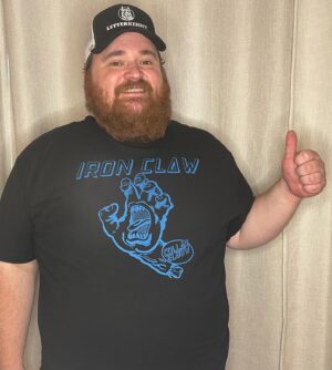 K. Trevor Wilson Instagram - This is my Iron Claw shirt from @collarxelbow. The Claw, a favourite move of the Von Erichs, the Windham/Mulligans and the Rashkes, is the epitome of a pro wrestling move. It is up there with the Heart Punch and the Bionic Elbow. Even though it looks easy to escape, no one escapes the Iron Claw