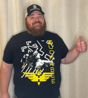 K. Trevor Wilson Instagram - This is my Golden Grappler @travis_huckabee shirt. Travis went out of his way to send me his shirt asking only that I please wear it in one of my posts. I watched some of his stuff from Chikara, solid work, nice submission and suplex based offence, really like that swinging cutter. Will keep my eye out for more. Thanks for the shirt