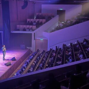 Kanan Gill Instagram - 21 shows, 19 cities, 3 illnesses, 2kg. Touring (parts of) Europe was immensely rewarding. Thank you for coming.
 . . .
“Do you ever worry about becoming a self-parody?”

The clump of moss on the rock face frowned for a minute. “In what sense? It’s your move, by the way”, it said indicating the chessboard stapled to the overhang.

“In the sense of becoming an employee of a previous version of yourself that was free.”

A passing eagle coughed pointedly at how loud we were being. I pressed myself closer to the rock face.

“Nope” said the moss, quite loudly, ignoring my shushing. “Being moss is embracing the plurality of existence, in the sense that there is no singular moss, there are outlines until there is mossing, and that space in which there is moss-ness, is moss. Dude seriously it’s your move.”

The chessboard has no pieces, since we were high up an infinite rock face and it was stapled sideways.

“So you’re talking about being as a process—“

“—A mossess”, corrected the moss.

“But you can still take a sliding window of the continuous change of self and call it who you used to be—“

“—what is this really about?” Interrupted the moss, finally lowering it voice and putting away its Nokia Ngage.

“That I’m worried lasting growth is impossible and decay is inevitable. I keep climbing from epiphany to epiphany, never further off the ground; fingers clasped around realisation, finding the odd abscess of wisdom to rest in. I’ve moved so much, but I’m still here.”

A shower of embarrassed rocks fell past from heights unknown to depths infinite, mumbling apologies. I wept bitterly.

“Ah silly” said the moss ruffling my hair. “There’s nowhere to reach. The path isn’t the climb, it’s the climber. You don’t scale these heights. You hang on till you fall off one day.”

A shuddering relief left my lips. “That’s it?”

“That’s it, smiled the moss. “Now, do you want to play your turn?”

“Sure. Knight to E3!”

“Dude this is Ludo.”