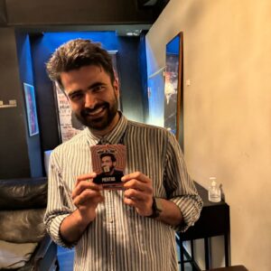 Kanan Gill Instagram - 21 shows, 19 cities, 3 illnesses, 2kg. Touring (parts of) Europe was immensely rewarding. Thank you for coming.
 . . .
“Do you ever worry about becoming a self-parody?”

The clump of moss on the rock face frowned for a minute. “In what sense? It’s your move, by the way”, it said indicating the chessboard stapled to the overhang.

“In the sense of becoming an employee of a previous version of yourself that was free.”

A passing eagle coughed pointedly at how loud we were being. I pressed myself closer to the rock face.

“Nope” said the moss, quite loudly, ignoring my shushing. “Being moss is embracing the plurality of existence, in the sense that there is no singular moss, there are outlines until there is mossing, and that space in which there is moss-ness, is moss. Dude seriously it’s your move.”

The chessboard has no pieces, since we were high up an infinite rock face and it was stapled sideways.

“So you’re talking about being as a process—“

“—A mossess”, corrected the moss.

“But you can still take a sliding window of the continuous change of self and call it who you used to be—“

“—what is this really about?” Interrupted the moss, finally lowering it voice and putting away its Nokia Ngage.

“That I’m worried lasting growth is impossible and decay is inevitable. I keep climbing from epiphany to epiphany, never further off the ground; fingers clasped around realisation, finding the odd abscess of wisdom to rest in. I’ve moved so much, but I’m still here.”

A shower of embarrassed rocks fell past from heights unknown to depths infinite, mumbling apologies. I wept bitterly.

“Ah silly” said the moss ruffling my hair. “There’s nowhere to reach. The path isn’t the climb, it’s the climber. You don’t scale these heights. You hang on till you fall off one day.”

A shuddering relief left my lips. “That’s it?”

“That’s it, smiled the moss. “Now, do you want to play your turn?”

“Sure. Knight to E3!”

“Dude this is Ludo.”