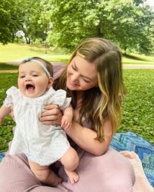 Katie Carpenter Instagram - we had a lovely picnic featuring my fave @hellyeahglutenfree treats 🍩 and FaceTiming with our mamas! 

Ryder came along too and isn’t 75 degrees the most PERFECT weather??! 

Cora is wearing a vintage dress made by my late grandma that I think I wore as a babe. 

And Kevin has been so sweet, he got me this beautiful birth stone necklace and printed out a poem that made me cry 🥹 (that we already spilled water on) 😂