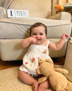 Katie Carpenter Instagram - 8 months (a day late!) 💖

Baby Cora has developed quite the personality lately. 

- she chats all the time 
- LOVES cheese more than life 🧀
- Enjoys sticking her tongue out 
- will show off her rolling outside of the crib, but only on the couch 😅
- Blows raspberries any chance she can get 
- Is eating 3 meals a day 
- can really put some dairy down and protests if we don’t serve her any 
- Kicking her legs in swim class more and more 

It’s so wild to see her preferences starting already! I remember when she was just a sleepy little lump, and now she’s closer to one year old than ever. It really does move fast!