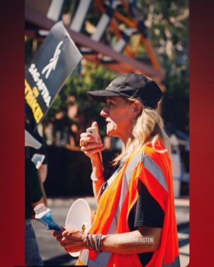 Kirsten Nelson Instagram - TY @b.side.photography for snapping this  Captain today! Proud to be a part of an amazing team of dedicated performers who just happened to have stepped up to keep our picket lines safe and keep morale high. We will walk together to finally see our ‘fearful trip done’!

Until then, Size 3XL Day-Glo orange High-Vis vest slayed… @sagaftra #sagaftrastrong