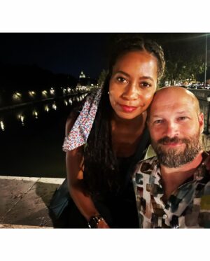 Kristen Ariza Instagram - We had 24 hours left and decided to end our European holiday exactly where it began 10 years ago. In Rome 🇮🇹We visited some old haunts and had pizza 🍕 at the first place we stopped way back when @darpoeta_trastevere We walked the streets til 3am which was exactly what we did when we arrived super jet-lagged back in the day, and had fun recreating some photos as well. Same scarf on my head (thanks Mom ❤️) and one of us has more hair, the other a bit less 🤔 Leaving here with a full belly, and a grateful heart to have made new friends, spent time with old friends and renewed vows with my Love @paddydemsey Til next time ✌🏾
.
.
.
#thenandnow #tenthanniversarytour #italy #glowup 💚🤍❤️ #keepsgettingbetter #pistolaoeople #romanholiday #graziegraziegrazie