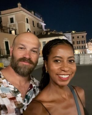 Kristen Ariza Instagram - We had 24 hours left and decided to end our European holiday exactly where it began 10 years ago. In Rome 🇮🇹We visited some old haunts and had pizza 🍕 at the first place we stopped way back when @darpoeta_trastevere We walked the streets til 3am which was exactly what we did when we arrived super jet-lagged back in the day, and had fun recreating some photos as well. Same scarf on my head (thanks Mom ❤️) and one of us has more hair, the other a bit less 🤔 Leaving here with a full belly, and a grateful heart to have made new friends, spent time with old friends and renewed vows with my Love @paddydemsey Til next time ✌🏾
.
.
.
#thenandnow #tenthanniversarytour #italy #glowup 💚🤍❤️ #keepsgettingbetter #pistolaoeople #romanholiday #graziegraziegrazie