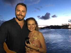 Kym Jackson Instagram - And theeen 6 months after we started dating - when your plans of proposing at burning man with a plastic electric glow ring @paultahoe and @brianaevigan found didn’t work out (I stole the ring from your bag because it was shiny and you couldn’t get reception to call my dad for permission) - you took me to Hawaii to “meet your parents”.

You proposed on the beach just after Sunset with a song you’d written the day before.. you remembered most of the words and made up the rest on the spot and it was absolutely perfect! 😻😻😻

My response was easy: “of course I will! Of course!!!”

#engaged #engagedlife #fuckyes #soulmates #bestfriends #storyofus #thestoryofus #hawaii #proposal #husbandmaterial #happiliyeverafter #kahala #kahalahotel #sheratonhawaii