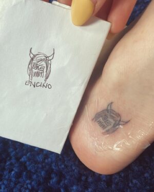 Kyra Elise Gardner Instagram - On the last day of @studio666movie I asked @davestruestories to draw me my next tattoo. He came back five minutes later with this little demon face he would scribble on the slate from time to time and told me I was lucky it wasn’t more vulgar ( aka 🍆) I would have gotten it either way 🤷🏻‍♀️ That movie was an experience I’ll never forget and thanks to Dave now I never will 🤘🏻 (also you’re welcome for the unsolicited feet pics - use them wisely)