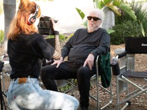 Kyra Elise Gardner Instagram - A very happy birthday to the great @johncarpenterofficial 🎉 Not pictured is me dropping his microphone before handing it to him because I was so nervous 😬 Very grateful to have been a small piece on @studio666movie in so many ways 🖤 📸: @ndrewstuart #studio666 #johncarpenter #davegrohl